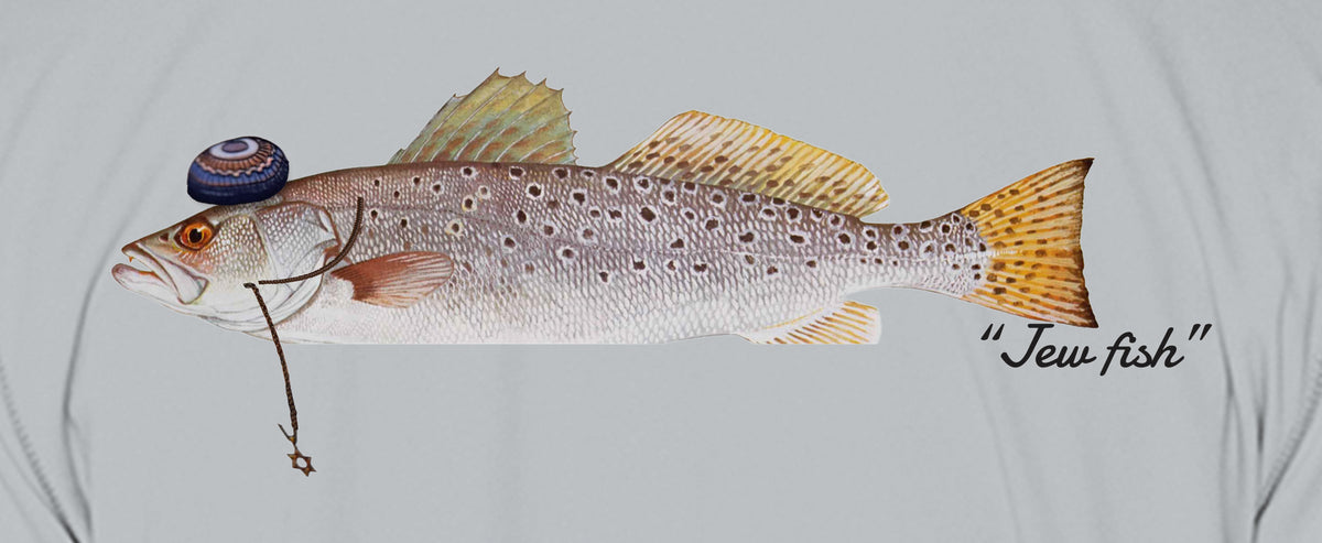Close-up of the speckled trout print on light grey fabric: kippah, Star of David chain, Jew fish script